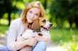 Young woman with Beagle dog in the park